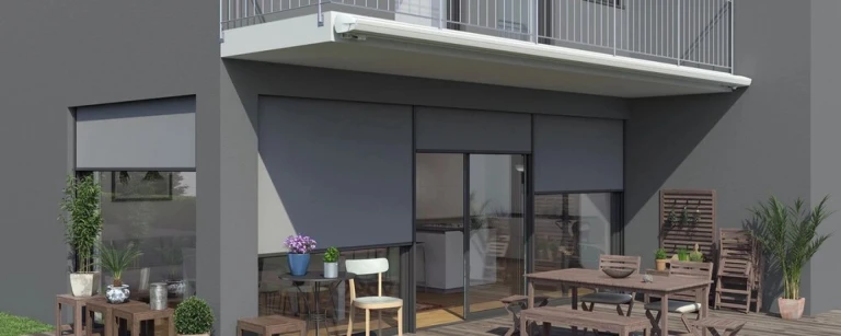 A modern terrace with gray outdoor screen blinds on the windows and balcony