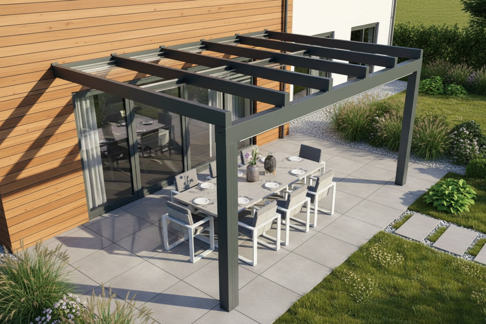 A modern gray aluminum pergola with a glass roof over a patio featuring a dining area next to a wood-clad house.