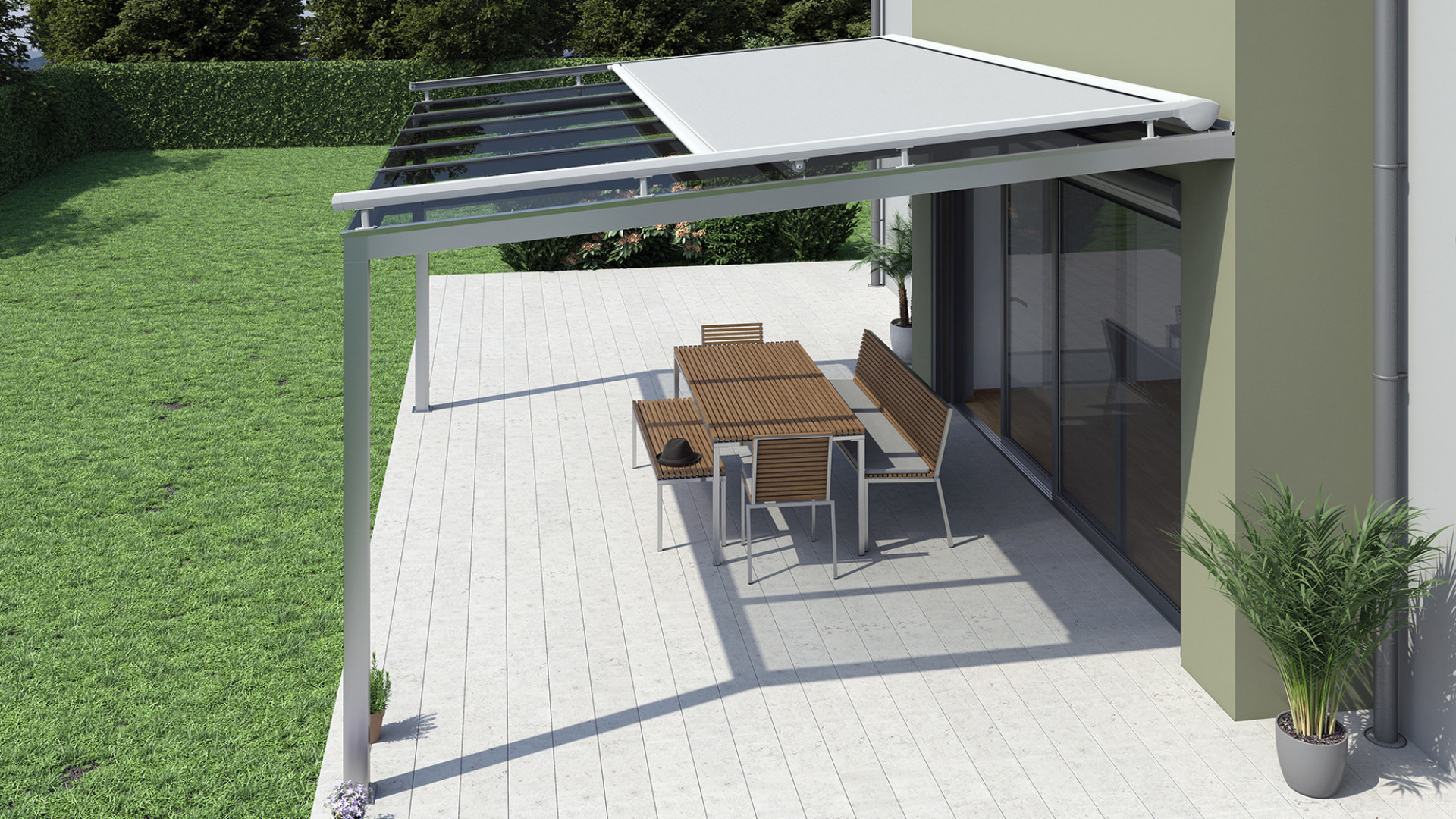 A modern awning over a glass-enclosed patio with outdoor seating and a lawn