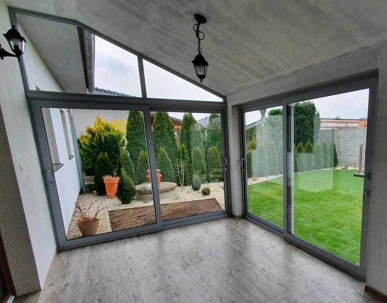 Modern terrace glazing with sliding doors and a view of the garden