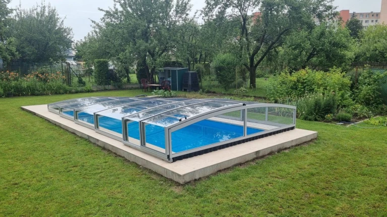 A low-profile PREMIER pool enclosure installed in a garden in Martin.