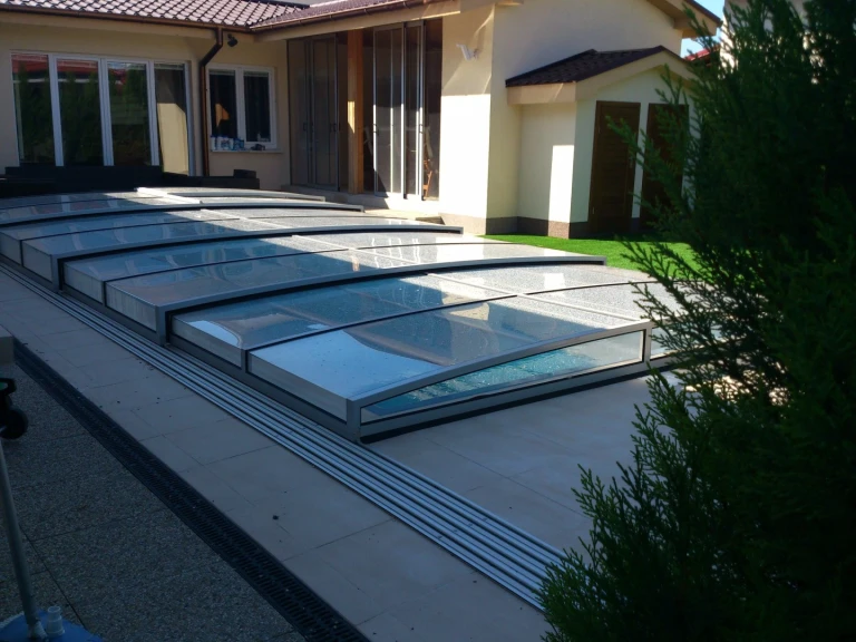 A modern, low-profile STAR pool cover on the terrace of a single-family home in Bratislava.