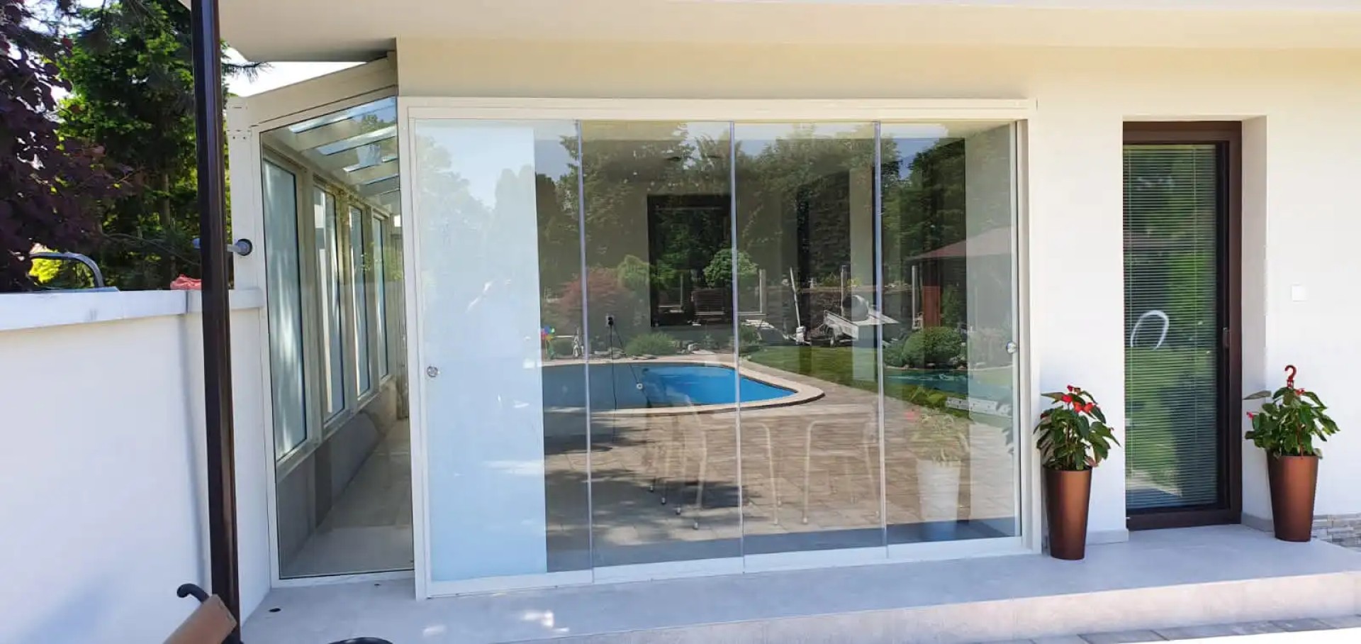 Modern frameless patio glazing on a single-family home overlooking the pool
