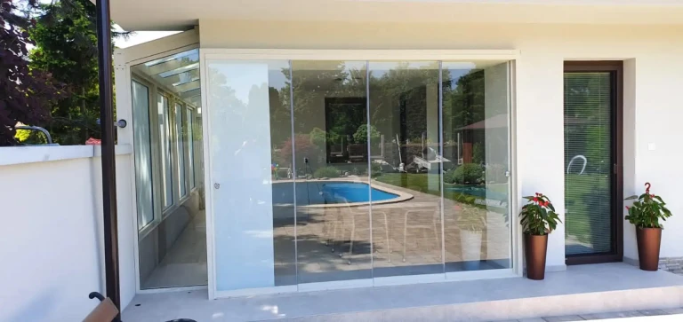 Modern frameless patio glazing on a single-family home overlooking the pool