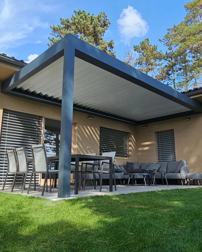 A modern bioclimatic pergola with an aluminum frame and adjustable slats on the terrace of a single-family home
