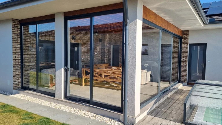 Modern aluminum patio glazing with sliding doors on a single-family home