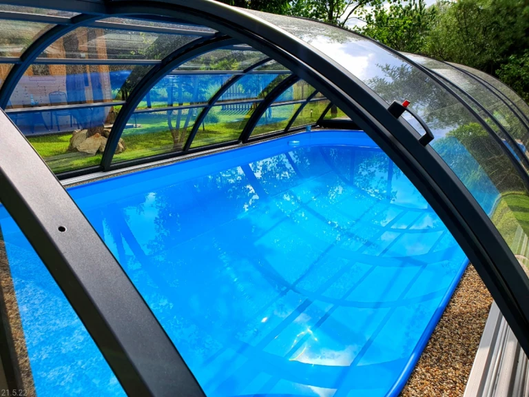 A close-up view of the blue pool with an arched canopy installed in the garden.