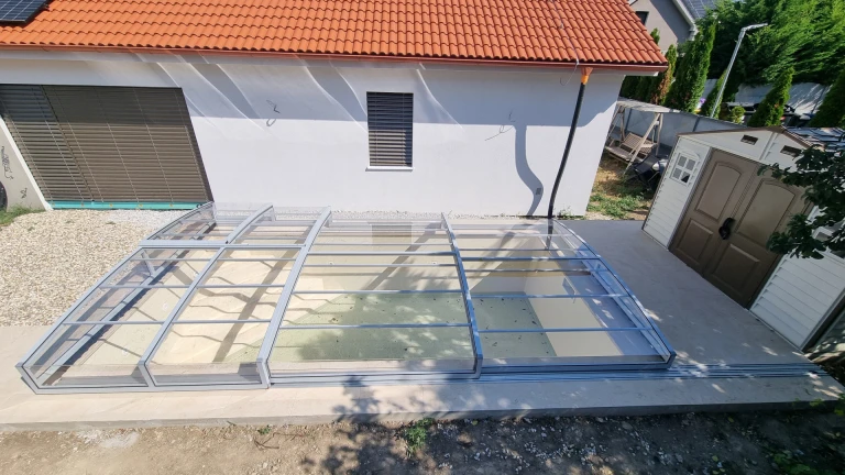 A bird's-eye view of the enclosed, modern, low-profile pool cover at a house in Senec.