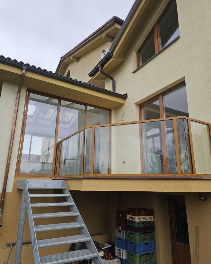 Modern terrace glazing with aluminum railings on a single-family home